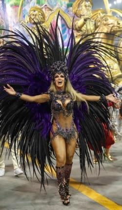 Transgender godmother Camila Prins from the Colorado do Bras samba school performs during a Carnival parade in Sao Paulo, Brazil, Feb. 23, 2020. Prins fulfilled a dream nearly three decades old.