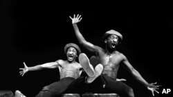 FILE — Performers Percy Mtwa, left, and Mbongeni Ngema in a scene from "Woza Albert" at the Market Theatre in Johannesburg, South Africa, in 1981. 