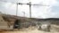 FILE - Workers and equipment are seen at a construction site at the Israeli settlement of Givat Zeev near the West Bank city of Ramallah, April 14, 2016. 