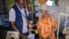 Adelle Mubalama, right, a tailor with a shop at Kenya's Kakuma refugee camp, was able to launch a business when she got a loan from Inkomoto. The organization helps small business entrepreneurs. (Photo courtesy of Inkomoto)