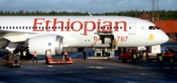 FILE - Ground crew personnel surround an Ethiopian Airlines Dreamliner, Sept. 20, 2012.