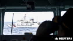 FILE - China Coast Guard ship is seen from an Indonesian Naval ship during a patrol at Indonesia's Exclusive Economic Zone sea in the north of Natuna island, Indonesia, Jan 11, 2020. (Antara Foto/M Risyal Hidayat/via Reuters)…