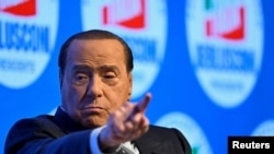 FILE PHOTO: Former Italian prime minister Silvio Berlusconi gestures during a campaign rally
