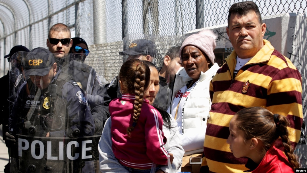 A group of Cubans hoping to apply for asylum, wait in front of U.S. Customs and Border Protection (CBP) agents on an international bridge at the border between Mexico and the U.S., in Ciudad Juarez, Mexico, March 31, 2019.