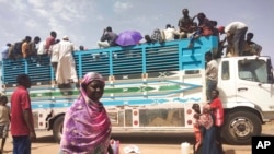 People board a truck as they leave Khartoum, Sudan, on June 19, 2023.