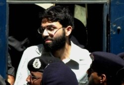 FILE- Ahmed Omar Saeed Sheikh, the alleged mastermind behind Wall Street Journal reporter Daniel Pearl's kidnap-slaying, appears at the court in Karachi, Pakistan, March 29, 2002.