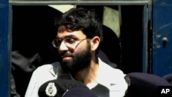 FILE- Ahmed Omar Saeed Sheikh, the alleged mastermind behind Wall Street Journal reporter Daniel Pearl's kidnap-slaying, appears at the court in Karachi, Pakistan, March 29, 2002.