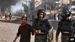 Paramilitary soldiers detain a supporter of Tehreek-i-Labaik Pakistan, a radical Islamist political party, during a clash, in Rawalpindi, Pakistan, April 14, 2021.