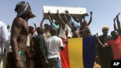 Mourners chant as some hold the coffin during the funeral of one of the victims killed earlier this week, at a cemetery in N'Djamena, Chad, May 1, 2021.