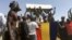 Mourners chant as some hold the coffin during the funeral of one of the victims killed earlier this week, at a cemetery in N'Djamena, Chad, May 1, 2021.