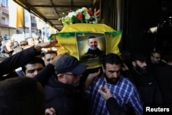 Mourners carry the body of Hezbollah commander Al-Hajj Mustafa Abdel Latif al-Zein during his funeral in Beirut's southern suburbs, Lebanon, on Nov. 30, 2024.