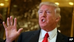 President-elect Donald Trump speaks with reporters in the lobby of Trump Tower in New York. Trump has offered views on U.S. relations with Asia that could indicate radical shifts in long-standing policy toward the region.