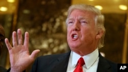 President-elect Donald Trump speaks with reporters in the lobby of Trump Tower in New York. Trump has offered views on U.S. relations with Asia that could indicate radical shifts in long-standing policy toward the region.