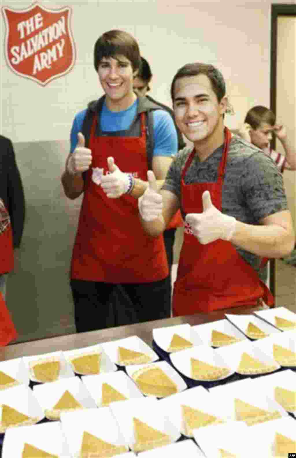 COMMERCIAL IMAGE In this photograph taken by AP Images for Nickelodeon, James Maslow, left, and Carlos Pena, right, of Big Time Rush pose for a photo while helping to serve a Thanksgiving lunch at The Salvation Army on Thursday, Nov. 24, 2011 in Dallas. (