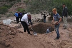 Men dig a mass grave for some of the women and children related to the extended LeBaron family who were killed by drug cartel gunmen, before their burial at the cemetery in La Mora, Sonora state, Mexico, Nov. 7, 2019.