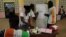 Polling agents count ballots at a polling station during the referendum for a new constitution, in Abidjan, Ivory Coast, Oct. 30, 2016. 