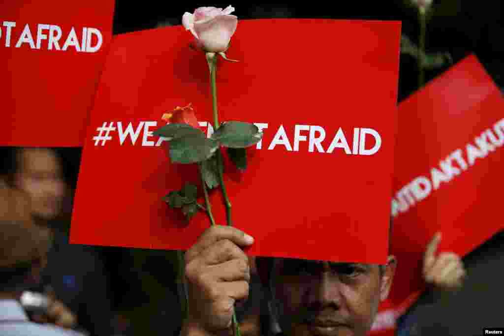 People hold placards reading &quot;We are not afraid&quot; during a rally at the scene of Thursday&#39;s deadly gun and bomb attack in central Jakarta, Indonesia.