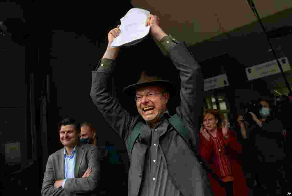 Milieudefensie director Donald Pols, holding a copy of the verdict, celebrates the outcome in the court case of Milieudefensie, the Dutch arm of the Friends of the Earth environmental organization, against Shell in The Hague, Netherlands