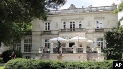 A man works in the garden of a high-end restaurant, Amber Room, July 12, 2019, where top Polish politicians and business people were secretly and illegally recorded over hundreds of hours in 2013 and 2014, in Warsaw, Poland. 