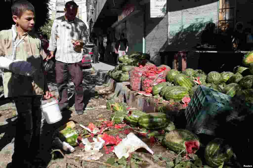 An injured youth at a vegetable market hit by what activists said was shelling by forces loyal to Syria's President Bashar al-Assad at al-Mashhad district in Aleppo, July 31, 2013.