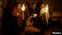 FILE - Israeli Arabs perform a Nativity scene for tourists in Nazareth, Dec. 22, 2008. 