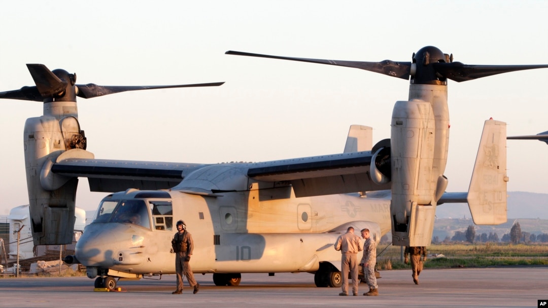 US Marine officers work next to an MV-22 Osprey vertical take off and lift aircraft , in the Sigonella airbase, Sicily, Thursday, March 24, 2011