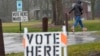 FILE - A voter braves a cold rain running to cast a ballot during the spring election, April 2, 2024, in Fox Point, Wisconsin.