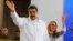 Venezuela's President Nicolas Maduro, left, and his wife Cilia Flores greet supporters upon their arrival to a meeting with Colombian citizens that reside in Venezuela, In Caracas, Venezuela, Tuesday, Sept. 25, 2018. 