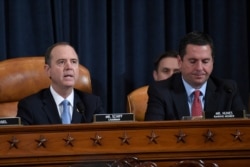 House Intelligence Committee Chairman Adam Schiff of Calif., left, speaks as Rep. Devin Nunes, R-Calif., the ranking member on the committee listens.