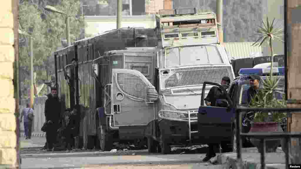 Egyptian police escorts stand by vehicles for general prisoner transport at Tora prison, Cairo, August 22, 2013.