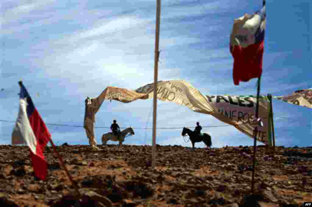 Police on horseback patrol near Chilean flags flying at the San Jose Mine near Copiapo, Chile, Tuesday Oct. 5, 2010. Chile's President Sebastian Pinera announced that his government is very close to pulling 33 miners to safety after they became trapped o