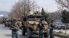 FILE - Foreign security personnel and Afghan police arrive at the site of an attack in Kabul, Afghanistan, March 6, 2020.