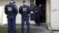 Anti-riot policemen stand outisde an appartment building, where suspects are being arrested by the police during an operation to dismantle a drug trafficking and clandestine immigration network in Mulhouse, eastern France, October 16, 2012. 
