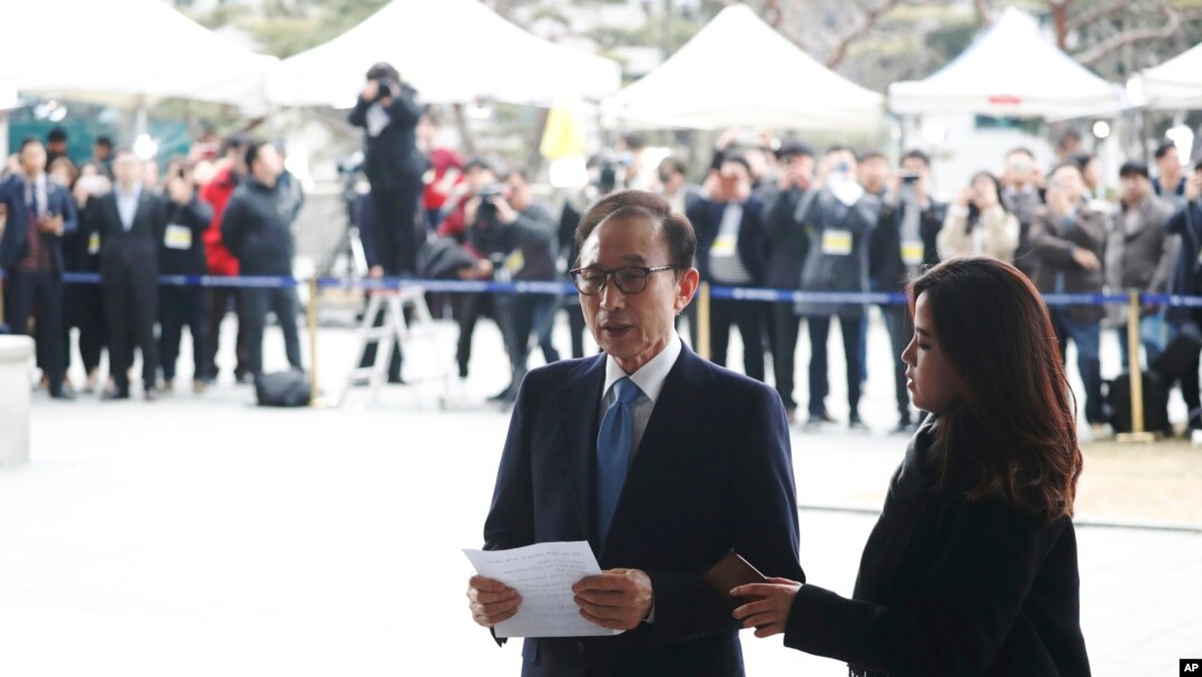 FILE - Former South Korean President Lee Myung-bak speaks upon arrival for questioning over bribery allegations at the Seoul Central District Prosecutors' Office in Seoul, South Korea, March 14, 2018. 