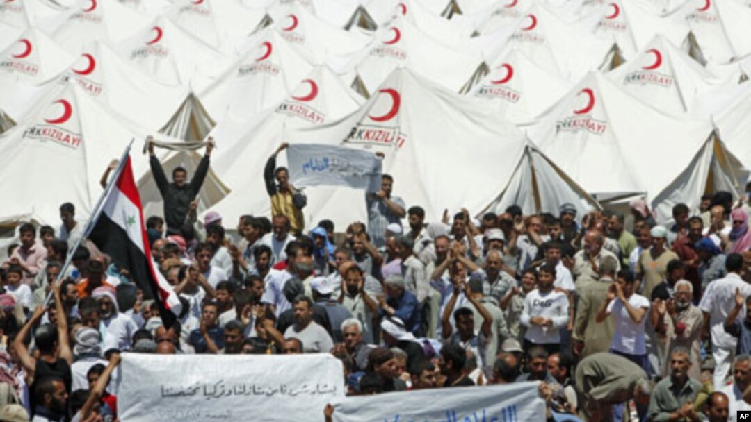Syrian refugees hold a demonstration in favor of Turkey at a refugee camp in the Turkish border town of Boynuegin in Hatay province, June 17, 2011