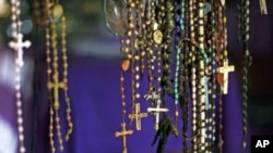 Crucifixes hang among the personal possessions of Rwandan victims at a genocide memorial inside the church at Ntarama just outside the capital Kigali, Rwanda, August 6, 2010