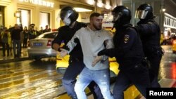 Police officers detain a participant in a protest against amendments to Russia's constitution and the results of a nationwide vote on constitutional reforms, in Moscow, July 15, 2020.