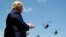 President Donald Trump applauds as Army helicopters fly overÂ during the Class of 2020 at a commencement ceremony on the parade field, at the United States Military Academy in West Point, N.Y., June 13, 2020. 