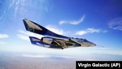 In this May 29, 2018 photo provided by Virgin Galactic, the VSS Unity craft flies during a supersonic flight test.