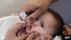 A medic administers a polio vaccine to a Palestinian child at Abdel Aziz Rantissi hospital in Gaza City's Nasr district which was reopened on Nov. 2, 2024.