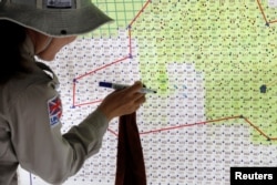 越南一名扫雷队队长在地图上标记检测到的区域，该地区靠近越南战争期间的前美国军事基地。(2020年3月4日)