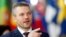 FILE - Slovak Prime Minister Peter Pellegrini gestures as he arrives at a European Union summit in Brussels, Belgium, March 22, 2018. 
