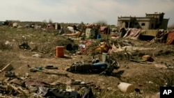 FILE - An Islamic State flag lies on the ground in an abandoned tent encampment after U.S.-backed Syrian Democratic Forces (SDF) fighters took control of Baghuz, Syria, March 23, 2019.