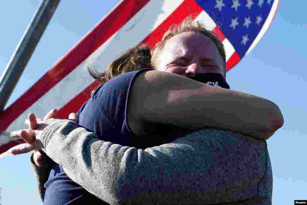 Supporters of Democratic U.S. presidential nominee Joe Biden celebrate near the site of his planned election victory