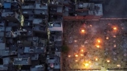 A mass cremation of COVID-19 victims is seen at a crematorium parking lot in New Delhi, on April 22, 2021.