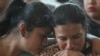 Women cry during the funeral of the victims of a bus accident at the cemetery of Santo Domingo Los Ocotes village in San Antonio La Paz, Guatemala on February 11, 2025.