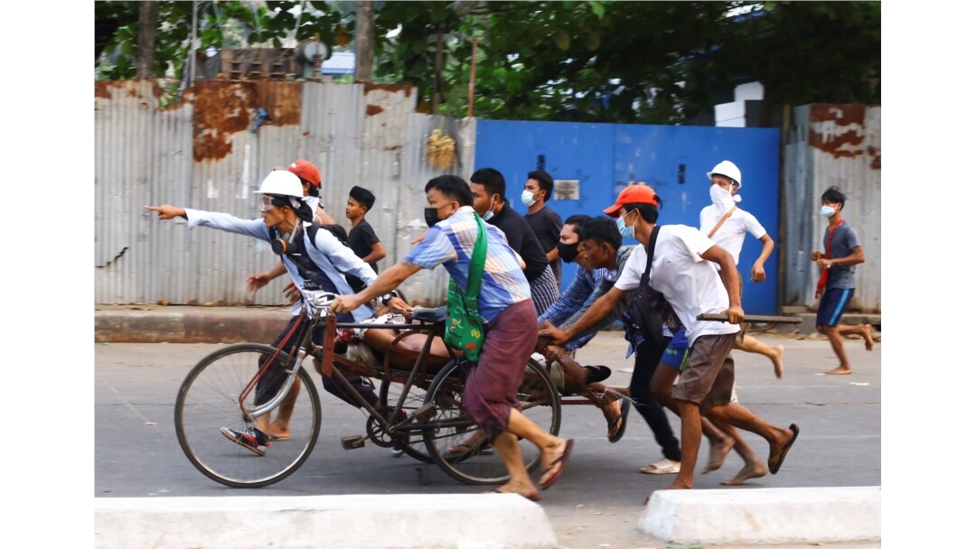 People transport a person who was shot during a security force crackdown on anti-coup protesters in Thingangyun, Yangon, Myanmar, March 14, 2021.