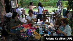 Volunteers restore used toys to donate them to vulnerable children as Christmas presents, at the non-profit foundation Hospital de los Peluches, or Hospital of Stuffed Animals, in Caracas, Venezuela, Thursday, Dec. 5, 2024. (AP Photo/Ariana Cubillos)