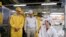 In this March 28, 2012 photo provided by Apple, Inc., Apple CEO Tim Cook, left, visits the iPhone production line at the newly-built manufacturing facility Foxconn Zhengzhou Technology Park, which employs 120,000 people.