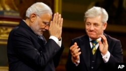 Britain's John Bercow, speaker of the House of Commons, applauds India's Prime Minister Narendra Modi after he delivers a speech at Parliament in London, Nov. 12, 2015.